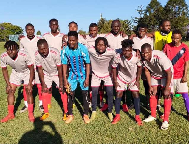 Wembley FC players in pink and white kit